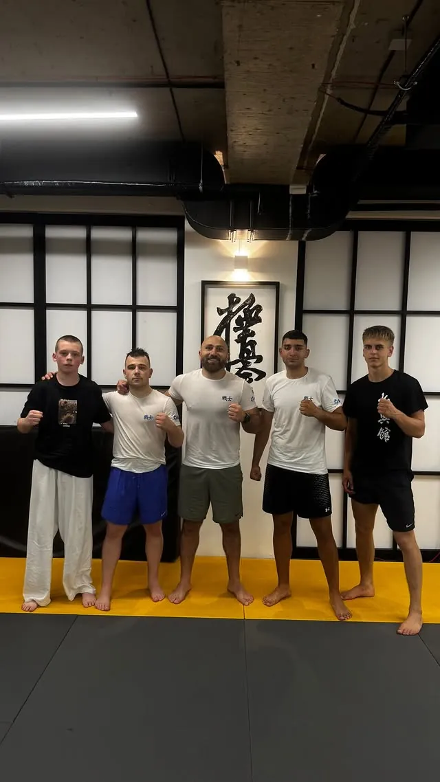Athletes from the KWU SENSHI Georgia camp standing with Sensei Nikoleishvili on the dojo mat in Tbilisi
